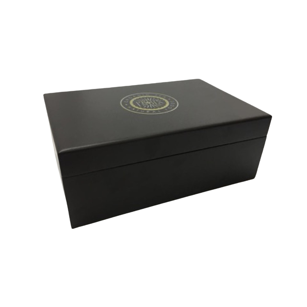 A closed, rectangular black box with a gold circular emblem on the lid, placed on a white background.