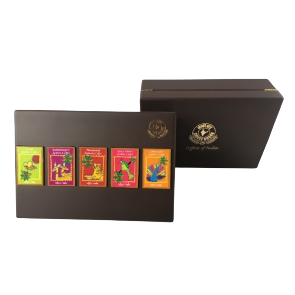 A brown gift box labeled Gifts of India with five colorful assorted tea packets displayed on the box lid. The packets are arranged in a row, each with distinct bright packaging.